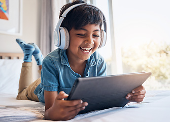 Image showing Happy boy, tablet and headphones on bed, smile or relax for streaming subscription, movie or funny video. Male child, digital touchscreen and happy in bedroom with audio tech, show or cartoon in home
