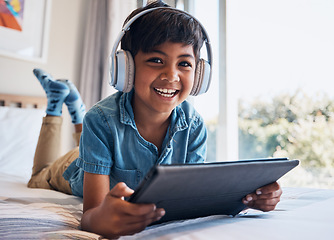 Image showing Boy, tablet and headphones on bed, portrait or smile for streaming subscription, movie or video to relax. Male child, digital touchscreen and excited in bedroom with audio, show or elearning in home