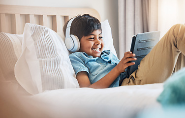Image showing Child, tablet and smile with headphones on bed for online games, watch movies or play educational app. Happy boy kid listening to multimedia, music or streaming cartoon in bedroom on digital tech