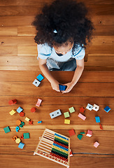 Image showing Above, child and toys for learning on the floor, home education and fun activity. House, young and a girl kid with blocks and abacus for recreation, math or perspective on the ground in childhood