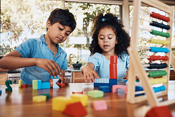 Image showing Siblings, children and playing building blocks for development, learning and growth on table in kitchen. Family, boy and girl child with toys for education, math, numbers and creativity in house