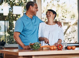 Image showing Couple, love and laugh while cooking food, cutting carrot or prepare vegetables for salad at home. Happy man, mature woman and hug for funny conversation, making healthy lunch meal or diet for dinner