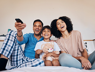 Image showing Smile, morning and family watching tv in a bedroom of their home together for streaming or entertainment. Parents, children or a boy laughing on the bed with his mother and father to enjoy television