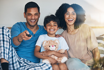 Image showing Happy, morning and a family watching tv on bed in their home together for streaming or entertainment. Parents, children or funny boy in the bedroom with his mom and dad to enjoy a television movie