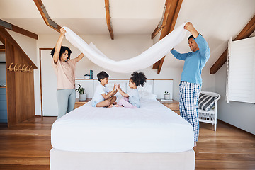 Image showing Blanket, fort and children on bed with parents for fun, play or hand game in their home. Bedroom, cover and kids with mother and father waking up, happy and weekend, day off or family time in house