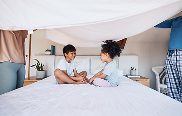Image showing Blanket, cover and children on bed with parents for fun, play or bond in their home. Bedroom, fort and kids with mother and father for morning games and enjoy weekend, day off or family care in house