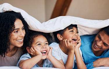 Image showing Happy, smile and children with their parents by a blanket on a bed together for bonding or connection. Happiness, love and young family from Colombia relaxing in the room of their modern house.