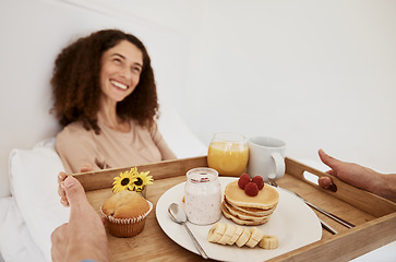 Image showing Breakfast, romance and woman in bed for surprise, anniversary celebration and special birthday. Morning, love and happy couple with food, pancake and juice on tray for wellness, nutrition and hunger