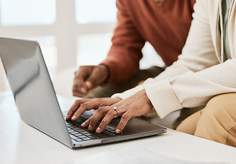 Image showing Hands, closeup and a couple with a laptop for internet, connection or research. Table, home and people typing on a computer for mortgage information, email or together for a movie online on a pc