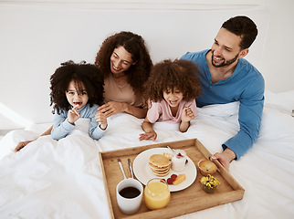 Image showing Parents, kids and breakfast in bed, morning or excited for love, bonding or care on holiday. Mother, papa and children in bedroom, food and smile together for nutrition, eating and happy family home