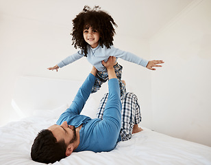 Image showing Flying, portrait and a child with a father in the bedroom for playing, happiness and bonding. Smile, house and a dad with a girl kid on the bed in the morning together for childhood and goofy