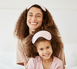 Image showing Mother, daughter and sleep mask, happiness in portrait and bonding with love and care in the morning. Woman, young girl and smile at home, pajamas and family, positivity and fun together in bedroom