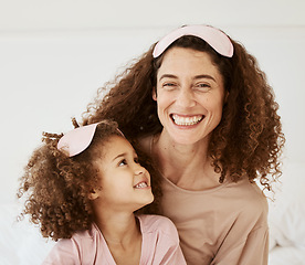Image showing Mom, daughter and sleep mask, happiness and bonding with toddler, love and care in the morning. Woman, young girl and smile at home with pajamas and family, positivity and fun together in bedroom