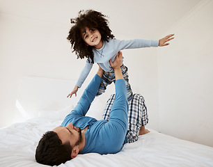 Image showing Playing, portrait and a child with a father in the bedroom for flying, happiness and bonding. Smile, house and a dad with a girl kid on the bed in the morning together for childhood and goofy