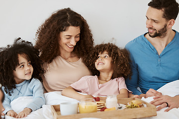 Image showing Parents, children and happy family breakfast in bed, eating food and rest together, bond and relax in apartment. Home bedroom, morning meal and interracial kids, mom and dad wellness, love and care