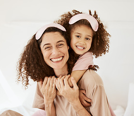 Image showing Mother, daughter and sleep mask, portrait and bonding with love, care and happy in the morning. Woman, young girl and hug at home with pajamas and family, positivity and fun together in bedroom