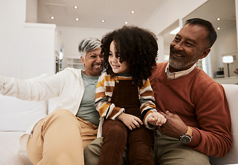 Image showing Grandparents, home smile and family kid, grandma and grandfather laughing, having fun and enjoy quality time together. Living room couch, grandfather and grandmother play with child during retirement