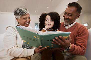 Image showing Grandparents, child and reading with book, sofa and thinking with support, learning and education. Senior man, woman and young kid with story, teaching and helping with development in family house