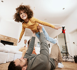 Image showing Dad, kid and airplane game on floor in home living room, bonding and love with care, relax and smile. Father, child and lift for plane, playing or happy on lounge carpet, apartment or family house