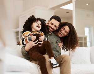 Image showing Family, father tickling child and mother, laughter and happiness at home with bonding and love. Fun together, comedy and parents are playful with kid, people being goofy on sofa with games and care