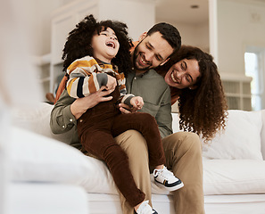 Image showing Family, dad tickling kid and mom, laughter and happiness at home with bonding and love. Fun together, comedy and parents are playful with child, people being goofy on sofa with games and care