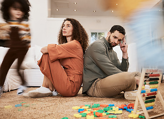 Image showing Parents, floor and stress with kid running, toys and motion blur for speed, naughty or overwhelmed in house. Mother, father and child on carpet, living room or family home with chaos, mess or burnout