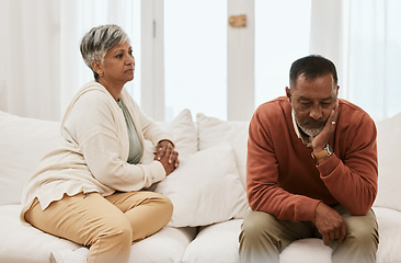 Image showing Talking, conflict and a senior couple on the sofa for a conversation about marriage stress. Sad, house and an elderly man and woman on the couch speaking about a divorce or relationship problem