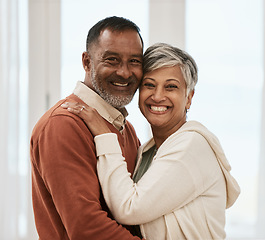 Image showing Happy, portrait and senior couple in home living room, bonding together and hug. Face smile, man and Indian woman in lounge for care, love or support for connection in healthy relationship at house