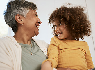 Image showing Grandmother, kid and funny laugh in home, bonding for connection and having fun playing together. Grandma, happy and smile of girl child, support and care for love in living room of interracial house