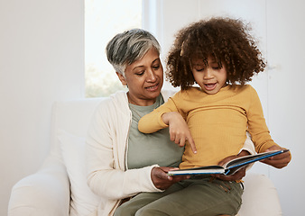 Image showing Home, grandmother or child reading book, point or gesture at kindergarten homework, story or study. Learning support, education or grandma storytelling fairytale to listening kid on living room chair