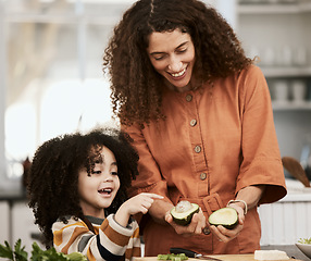 Image showing Family, avocado and a mother cooking with her daughter in the kitchen of their home together for nutrition. Food, health or diet with a woman teaching her child about eating green vegetables