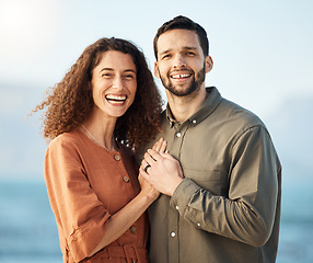 Image showing Couple, portrait and smile at beach, love and excited with holding hands, care and romance on holiday. Man, woman and happy for marriage, vacation and bonding by ocean, waves and outdoor in Naples