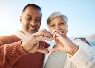 Image showing Senior couple, heart hands and beach portrait for love, icon or smile in summer, sign language or symbol. Man, woman and happy marriage with emoji, outdoor or together for holiday by ocean in Jakarta