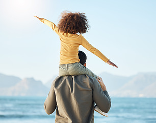 Image showing Piggyback, kid and father at beach view on vacation, holiday and bonding on mockup space. Dad, play and carrying child at ocean, having fun and family travel to sea together in support, care or love