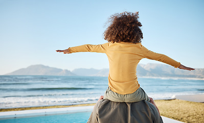 Image showing Father, child on shoulders and freedom at beach, bonding and piggyback, fun and games with back view. Man, young girl and playing, summer and care, love and adventure with parenting and childhood