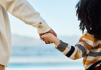 Image showing Family, holding hands and parent with a child on the beach while on summer vacation for travel together from the back. Love, children or nature with a kid and adult looking at the view of the ocean