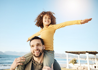 Image showing Father, kid and piggyback, freedom at beach with bonding and child on shoulders, fun and games together. Man, young girl and playful, summer and smile with love and adventure, parenting and childhood