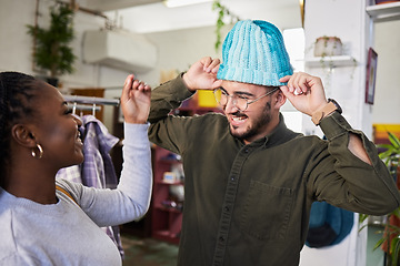 Image showing Shopping, couple and a man with a hat for fashion at a retail store with clothes or sale. A man and woman together in a shop or a happy customer with product choice in a boutique or mall with a smile