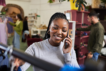 Image showing Shopping, woman and phone call for talking fashion at a retail store with sale or discount. Black person or happy customer on smartphone for product choice, promotion or communication in a boutique