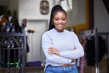 Image showing Happy black woman, portrait and arms crossed in clothes store, thrift shop or fashion workshop in owner pride. Smile, confident and professional designer in small business or retail donation industry