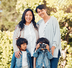 Image showing Woman, mother or children in park for photography on mothers day for support, family bond or love. Portrait, smile or mature mom with kids or happy daughter in garden together with camera for picture