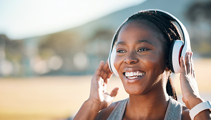 Image showing Headphones, mockup and black woman at fitness training or outdoor workout for health wellness and enjoy music. Smile, African and athlete or person streaming audio or radio for exercise in a park