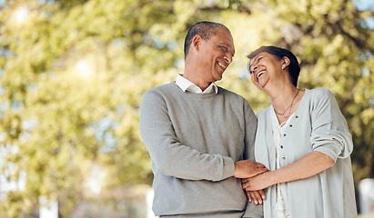 Image showing Outdoor, funny and senior couple holding hands, love and happiness with joy, romance and relationship. People, elderly man and old woman in a park, nature and romantic with marriage, memory and care