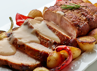 Image showing sliced roast pork with vegetables and sauce