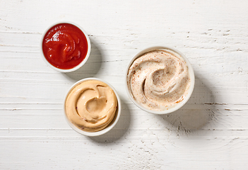 Image showing various sauces on white wooden table