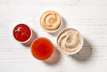 Image showing various sauces on white wooden table