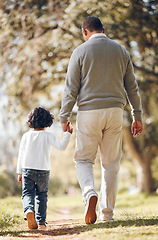 Image showing Back, holding hands and a child with a grandfather in nature for walking, bonding and care. People, family and a senior man with a kid and support, trust or together in a park or garden for love