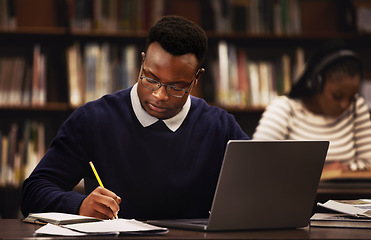 Image showing Student, man and writing in library for studying, research and planning in university, scholarship and education. African person with online test and computer for language, e learning or philosophy