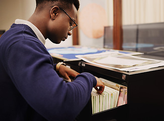 Image showing School research, campus and a black man in a library for knowledge, learning or studying. University, scholarship and a young African person or student looking at books for decision or choice