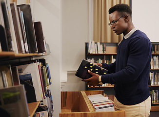 Image showing Librarian man, shelf and book with thinking, packing or stock for admin, organized and ideas in workplace. African employee, university or library expert with research, book and reading at workplace